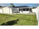 Large backyard with a shed, screen enclosure and plenty of green grass at 2820 Tamarind Dr, Edgewater, FL 32141