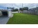 Spacious backyard with lush green lawn, featuring a storage shed and privacy fence at 2820 Tamarind Dr, Edgewater, FL 32141