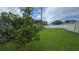 Spacious backyard with lush green grass, enclosed by a well-maintained white privacy fence at 2820 Tamarind Dr, Edgewater, FL 32141
