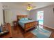 Bright bedroom featuring hardwood floors, natural light, and a view of the private pool area at 2820 Tamarind Dr, Edgewater, FL 32141