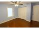 Bright bedroom featuring hardwood floors, a window with natural light, and a closet with bi-fold doors at 2820 Tamarind Dr, Edgewater, FL 32141