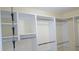 Walk in closet featuring custom shelving with metal hanging rods for ample storage at 2820 Tamarind Dr, Edgewater, FL 32141
