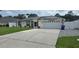 Charming single-story home with solar panels, two-car garage, and a well-maintained lawn at 2820 Tamarind Dr, Edgewater, FL 32141