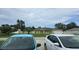 Charming single-story home with a manicured lawn and a welcoming front entrance behind parked cars at 2820 Tamarind Dr, Edgewater, FL 32141