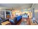 Open-concept living room featuring hardwood floors, ceiling fans and adjacent kitchen at 2820 Tamarind Dr, Edgewater, FL 32141