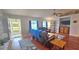 Inviting living room featuring hardwood floors, a TV, and an adjacent, sunlit entryway at 2820 Tamarind Dr, Edgewater, FL 32141