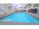 Private backyard pool with decorative tile, surrounded by colorful seating and a privacy fence at 2820 Tamarind Dr, Edgewater, FL 32141
