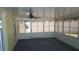 The sun room has large windows and a ceiling fan at 2820 Tamarind Dr, Edgewater, FL 32141