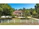 Charming two-story home with landscaped yard, white fence and mature trees offers curb appeal at 305 Country Circle E Dr, Port Orange, FL 32128