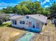 Charming single-story home with light colored siding, a quaint front yard and blue sky at 310 Legion Pl, Port Orange, FL 32129