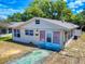 Front exterior featuring a covered porch, natural light from the windows, and street view at 310 Legion Pl, Port Orange, FL 32129