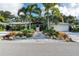 Charming home featuring tropical landscaping, gravel driveway, and a well-maintained exterior at 403 Ocean Ave, New Smyrna Beach, FL 32169