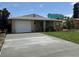 Charming single-story home featuring a garage and a well-maintained front yard with lush green grass at 4219 Oriole Ave, Port Orange, FL 32127