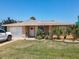 Charming one-story home with a stone facade, well-manicured lawn, and attached garage at 4219 Oriole Ave, Port Orange, FL 32127