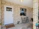 Inviting front porch with seating area and decorative stone columns at 4219 Oriole Ave, Port Orange, FL 32127