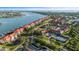 An aerial view featuring waterfront condo living with pools, tennis courts, and boat access at 445 Bouchelle Dr # 301, New Smyrna Beach, FL 32169