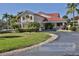 Beautifully landscaped Bouchelle Island Clubhouse with red tile roof and manicured lawn at 445 Bouchelle Dr # 301, New Smyrna Beach, FL 32169