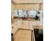 Cozy kitchen featuring wood cabinets, laminate countertops, and a stainless steel sink at 445 Bouchelle Dr # 301, New Smyrna Beach, FL 32169