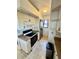 Compact kitchen with white cabinets, stainless steel appliances, and tile flooring at 445 Bouchelle Dr # 301, New Smyrna Beach, FL 32169