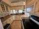 Functional kitchen featuring tile countertops, white cabinets, and stainless steel appliances at 445 Bouchelle Dr # 301, New Smyrna Beach, FL 32169
