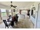 Open-concept living area featuring a ceiling fan, balcony access, and dining space at 445 Bouchelle Dr # 301, New Smyrna Beach, FL 32169