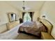 Spacious primary bedroom with a ceiling fan and sliding doors leading to a balcony at 445 Bouchelle Dr # 301, New Smyrna Beach, FL 32169