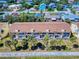 Aerial view of multi-Gathering residential building showing the roofs and balconies, palm trees in complex with parking in front at 4752 S Atlantic Ave # 1, Ponce Inlet, FL 32127