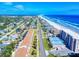 Aerial view of beachfront homes and condos with a road leading to the ocean at 4752 S Atlantic Ave # 1, Ponce Inlet, FL 32127