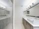 Bathroom features a glass enclosed shower and double sink vanity with white countertops at 4752 S Atlantic Ave # 1, Ponce Inlet, FL 32127