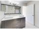 Modern bathroom featuring double sinks, a large mirror, and sleek cabinetry, with an open doorway leading to another room at 4752 S Atlantic Ave # 1, Ponce Inlet, FL 32127