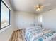Bright bedroom with wood floors and a view from a large window at 4752 S Atlantic Ave # 1, Ponce Inlet, FL 32127