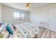 Bright bedroom features a ceiling fan, hardwood floors and a large window with great natural light at 4752 S Atlantic Ave # 1, Ponce Inlet, FL 32127