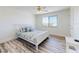Bright bedroom features a ceiling fan, hardwood floors and a large window with great natural light at 4752 S Atlantic Ave # 1, Ponce Inlet, FL 32127