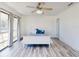 Bright bedroom with wood floors and a sliding glass door to the balcony at 4752 S Atlantic Ave # 1, Ponce Inlet, FL 32127