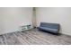 Modern bedroom with sleek gray flooring, futon sofa, and a surfboard at 4752 S Atlantic Ave # 1, Ponce Inlet, FL 32127