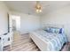 Bright bedroom features a ceiling fan, hardwood floors and a large window with great natural light at 4752 S Atlantic Ave # 1, Ponce Inlet, FL 32127