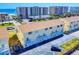 Aerial view of condos with parking, balconies, and beach access on a sunny day at 4752 S Atlantic Ave # 1, Ponce Inlet, FL 32127