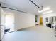 Spacious garage with white walls and an entry door to the house at 4752 S Atlantic Ave # 1, Ponce Inlet, FL 32127