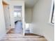 Hallway shows dark stained wood look floors that connect to the upper floor and a bedroom at 4752 S Atlantic Ave # 1, Ponce Inlet, FL 32127