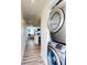 Hallway featuring stacked washer/dryer with views to the living room at 4752 S Atlantic Ave # 1, Ponce Inlet, FL 32127