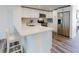 Bright kitchen with white cabinetry, stainless appliances, and wood-look flooring at 4752 S Atlantic Ave # 1, Ponce Inlet, FL 32127