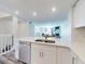 Bright, modern kitchen with a stainless steel dishwasher, quartz countertop and open to the living area at 4752 S Atlantic Ave # 1, Ponce Inlet, FL 32127