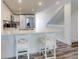 Bright kitchen island with white cabinetry, a stainless steel sink, and modern countertops at 4752 S Atlantic Ave # 1, Ponce Inlet, FL 32127