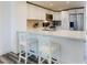 Bright kitchen island with white cabinetry, modern countertops, and sleek appliances at 4752 S Atlantic Ave # 1, Ponce Inlet, FL 32127