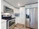 Bright kitchen featuring white cabinetry, stainless steel appliances, and modern countertops at 4752 S Atlantic Ave # 1, Ponce Inlet, FL 32127