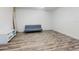 Cozy living room featuring modern flooring, a comfortable futon, and a stylish console, surfboard on the wall at 4752 S Atlantic Ave # 1, Ponce Inlet, FL 32127
