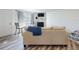 Cozy living room with a stone fireplace, wood floors, and a sliding door to a balcony at 4752 S Atlantic Ave # 1, Ponce Inlet, FL 32127