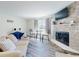 Inviting living room featuring a stone fireplace, sleek furniture, and stylish decor at 4752 S Atlantic Ave # 1, Ponce Inlet, FL 32127