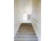 Staircase with white handrail and gray wood treads at 4752 S Atlantic Ave # 1, Ponce Inlet, FL 32127