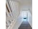 Bright staircase with a white railing leads to a door with a welcome mat at 4752 S Atlantic Ave # 1, Ponce Inlet, FL 32127